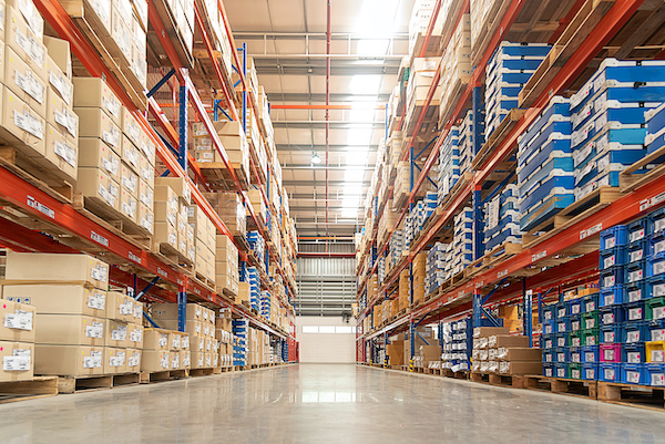Rows of shelves with goods boxes in huge distribution .warehouse at industrial storage factory.
